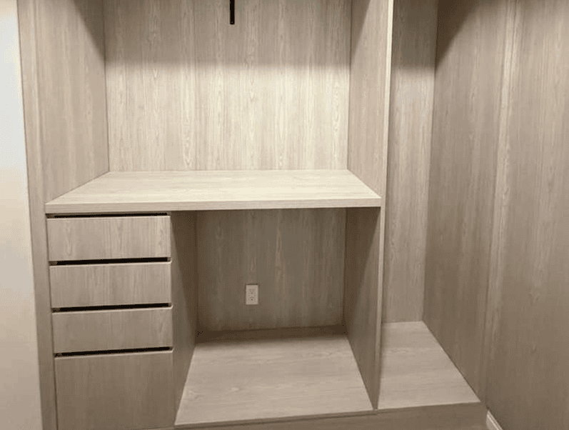Wooden closet with drawers and shelves.