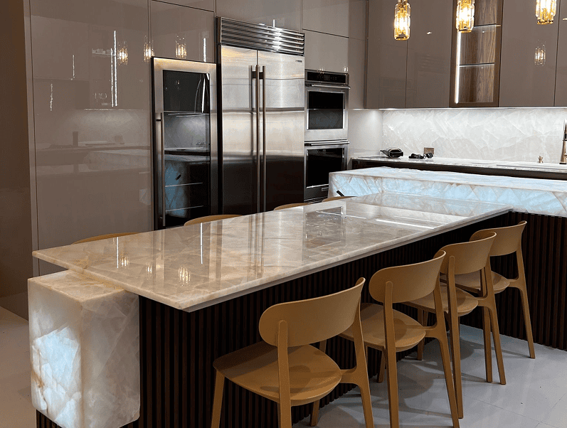 Modern kitchen with island and wooden chairs.